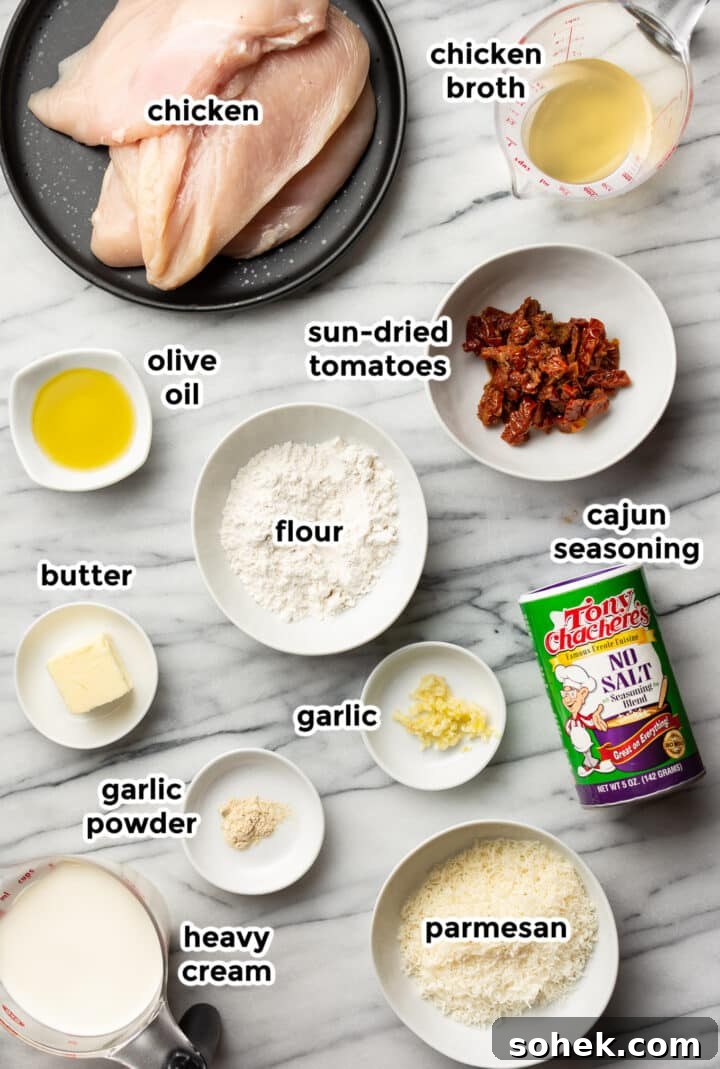 ingredients for creamy cajun chicken in prep bowls on a countertop