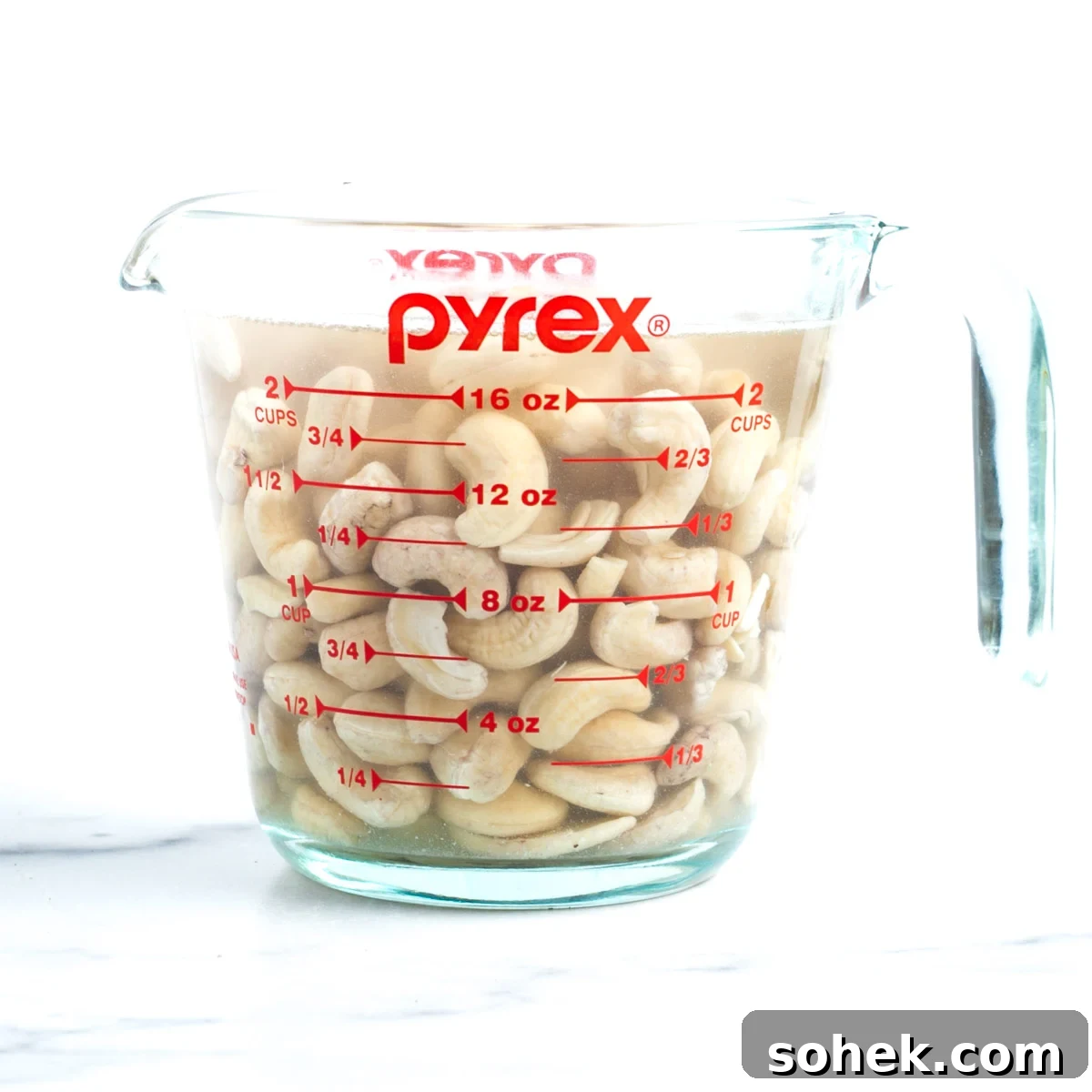 Apple Walnut Tart with Creamy Vegan Cashew Custard Recipe 4 Raw cashews in a glass measuring cup, covered with water.