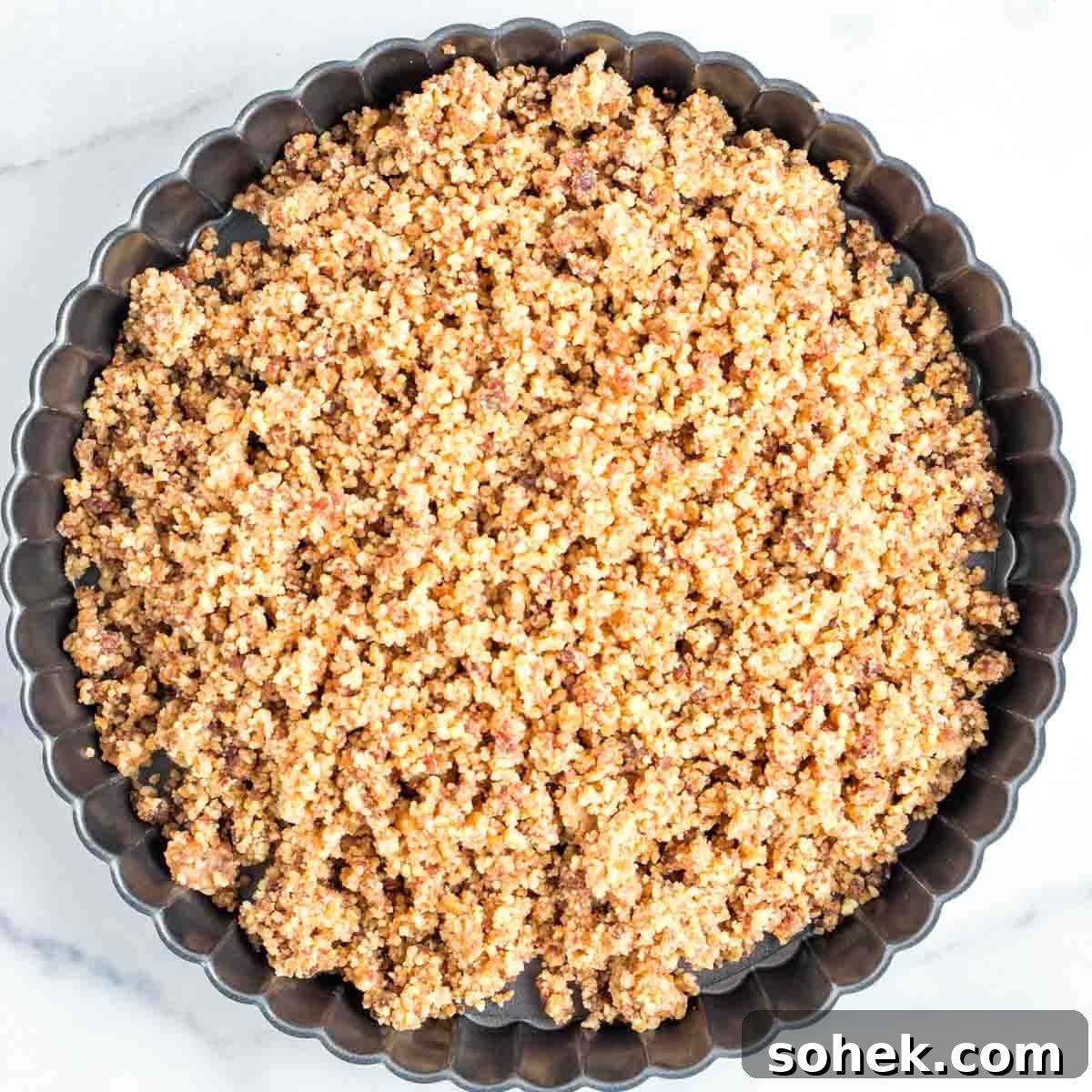 Apple Walnut Tart with Creamy Vegan Cashew Custard Recipe 7 Scalloped edge tart pan filled with crumbly walnut/date mixture.