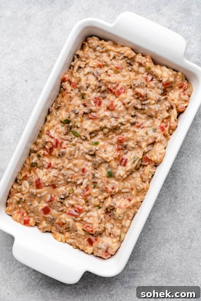 Cheesy Hamburger Rice Casserole Recipe for Comforting Weeknight Meals 7 Rice and hamburger casserole in a white baking dish.
