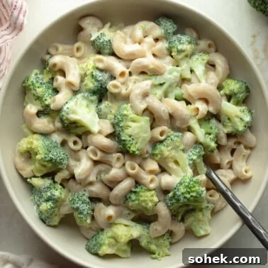 overhead view of vegan white mac and cheese with broccoli in a bowl.