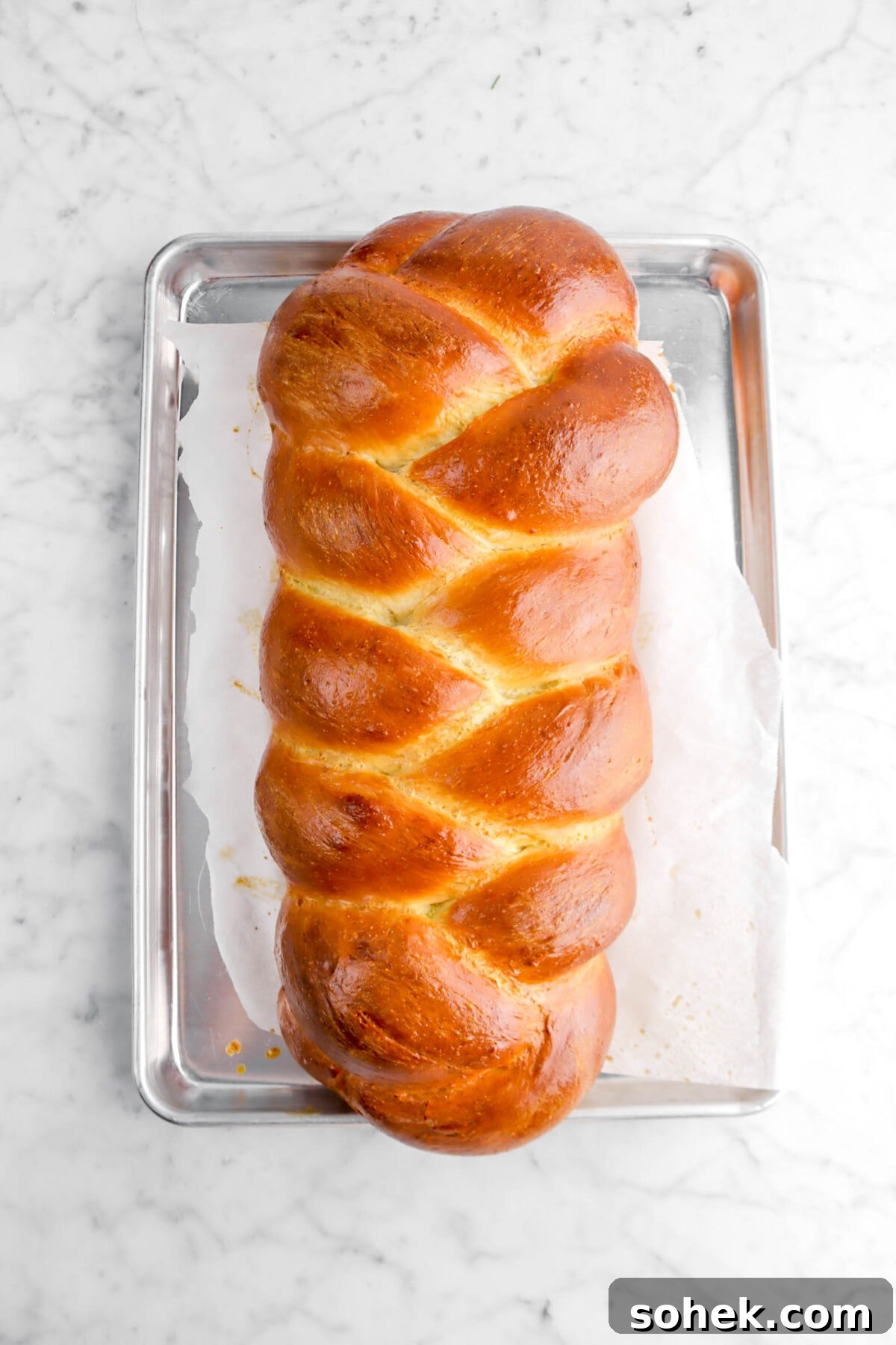 baked challah on lined sheet pan