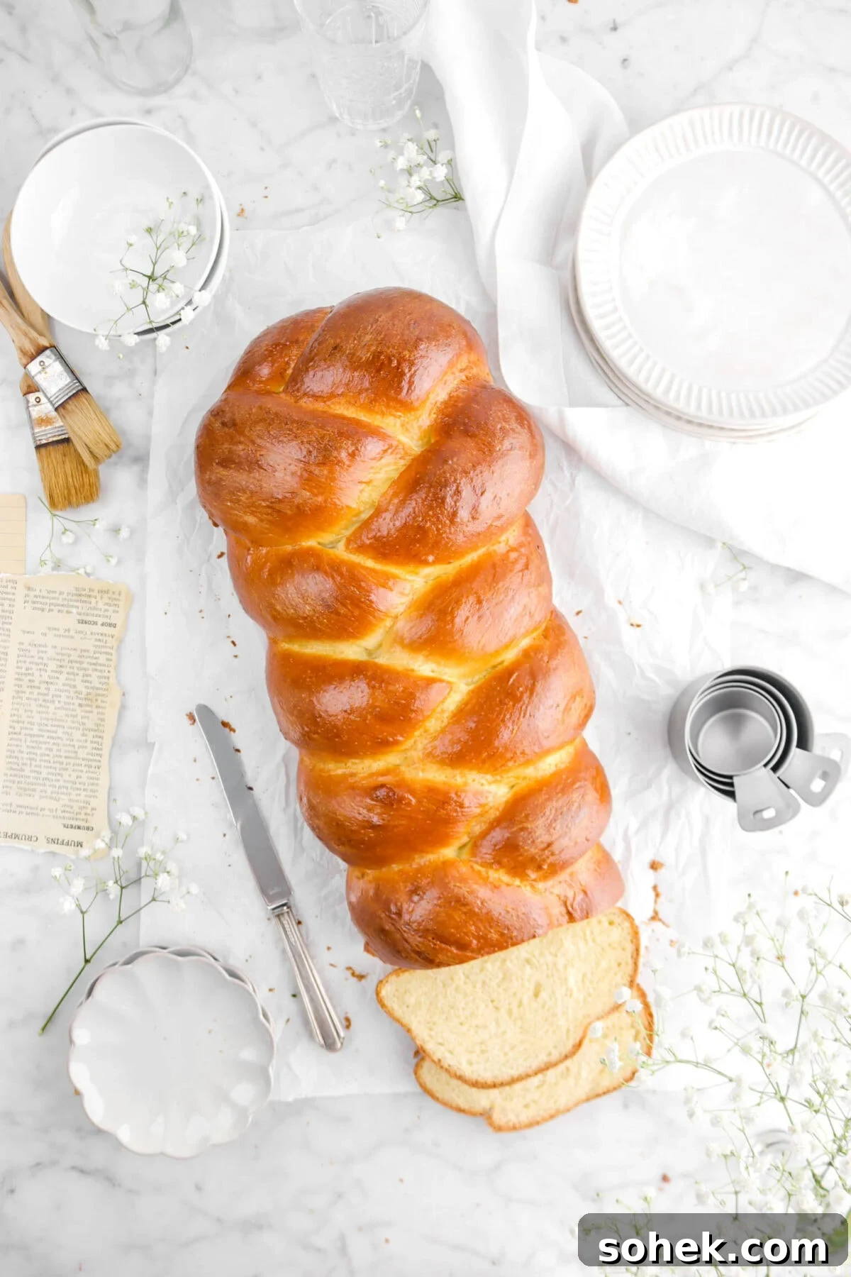 overhead shot of challah with two slices cut in front