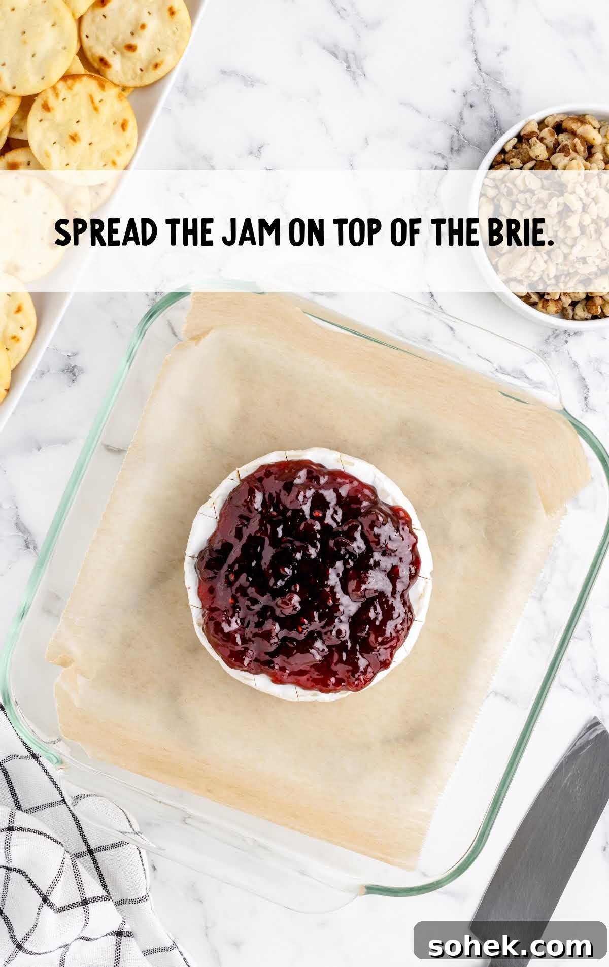 Baked Brie with Jam: Gooey Appetizer Recipe for Entertaining 5 jam spread on top of the baked brie