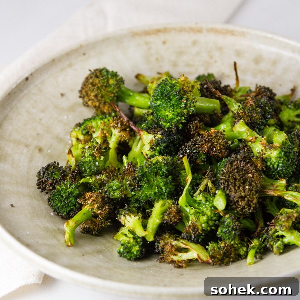 Crispy Air Fryer Roasted Broccoli Recipe 7 square crop of Air Fryer Roasted Broccoli in a white bowl