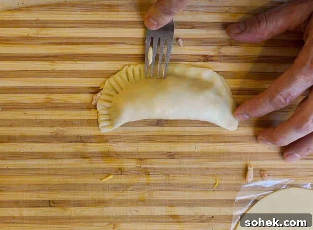 Crispy Air Fryer Empanadas: Homemade Recipe for Perfect Filling 5 crimping the empanadas