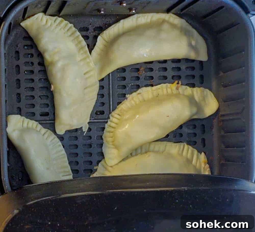 Crispy Air Fryer Empanadas: Homemade Recipe for Perfect Filling 6 empanadas in air fryer before cooking