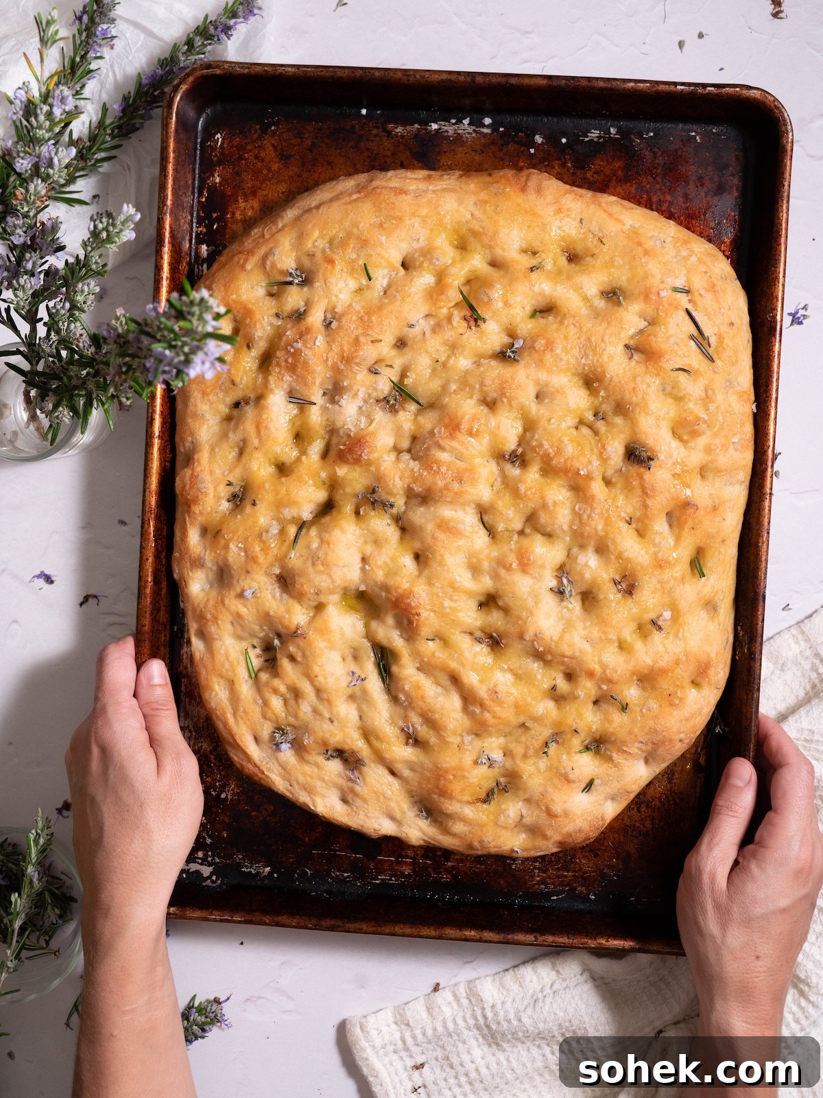 Crispy Sourdough Discard Focaccia with Olive Oil and Herbs 11 Sourdough discard focaccia with rosemary flowers and sea salt