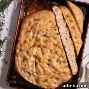 Crispy Sourdough Discard Focaccia with Olive Oil and Herbs 14 Rosemary flower sourdough discard focaccia sliced to show interior texture