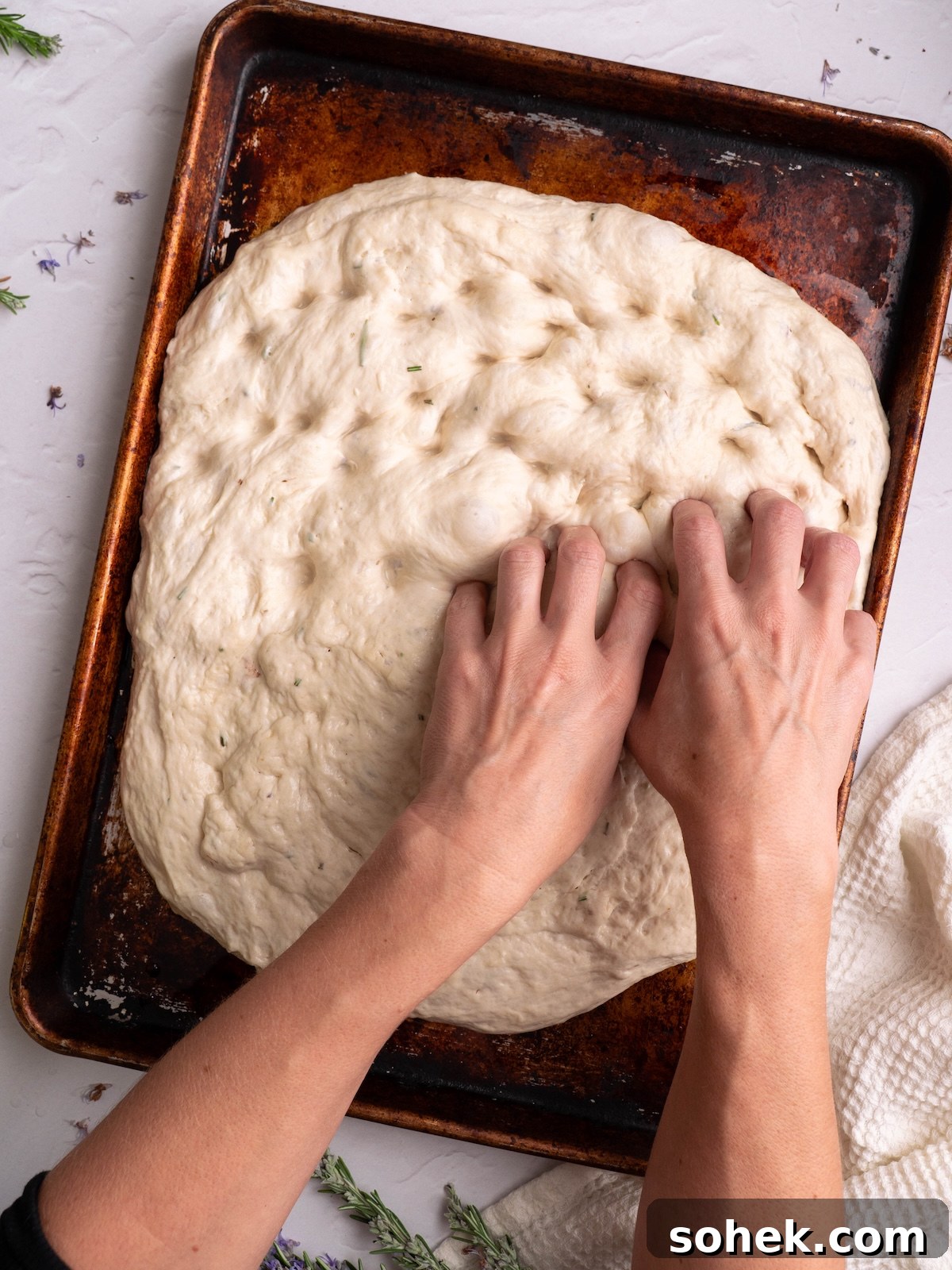 Crispy Sourdough Discard Focaccia with Olive Oil and Herbs 9 Dimpling focaccia dough with fingers