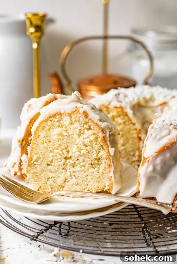 coconut pound cake on a plate with a fork.