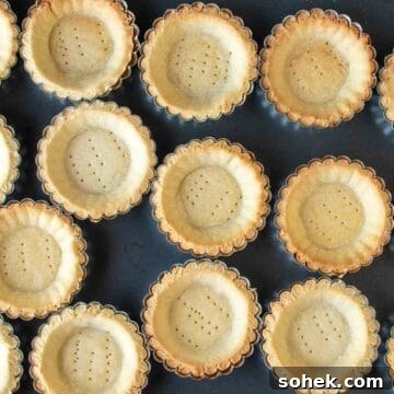 Mini Fresh Fruit Tarts Recipe: Bite-Sized Dessert for Parties 11 Overhead view of baked tartlet bases.