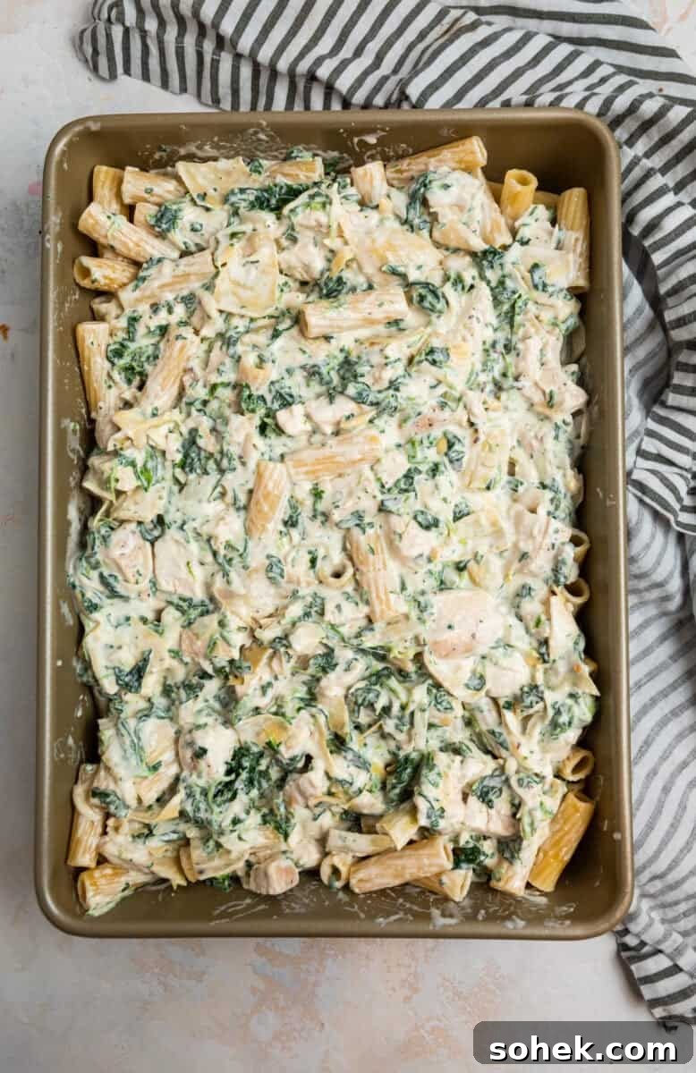 Spinach and Artichoke Chicken Casserole Recipe for Family Meals 8 Pan with chicken, spinach and artichoke casserole before baking.