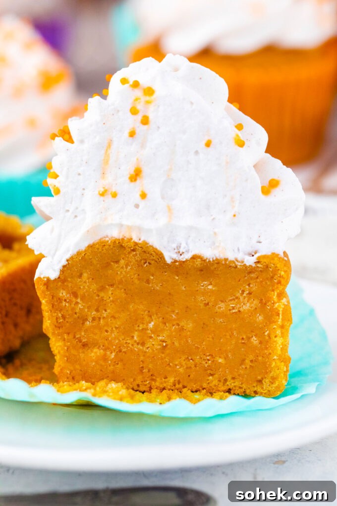 Creamy Sweet Potato Pie Cupcakes Recipe for Fall Desserts 12 Sweet potato pie cupcake topped with whipped cream sliced in half.