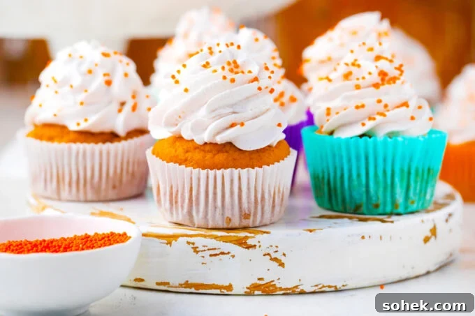 Creamy Sweet Potato Pie Cupcakes Recipe for Fall Desserts 3 Sweet potato pie cupcakes topped with cinnamon whipped cream.