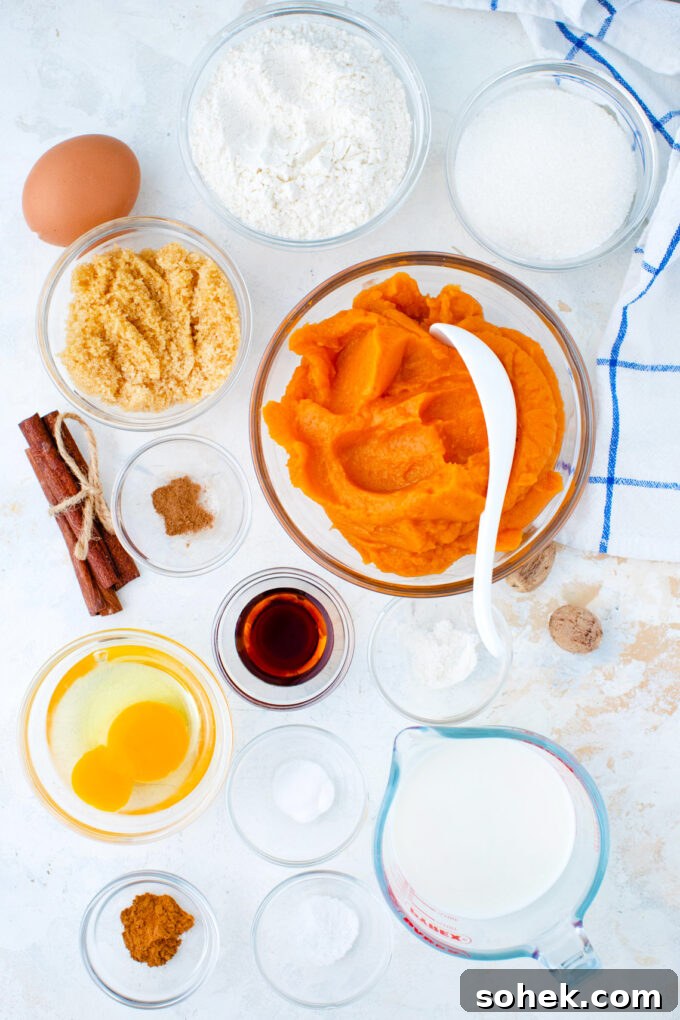 Creamy Sweet Potato Pie Cupcakes Recipe for Fall Desserts 4 Overhead shot of sweet potato pie cupcakes ingredients in bowls on a white surface.