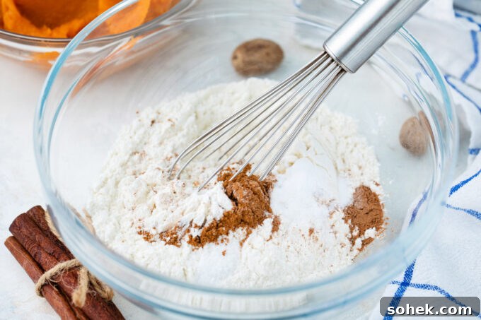 Creamy Sweet Potato Pie Cupcakes Recipe for Fall Desserts 6 Mixing flour with spices in a bowl.