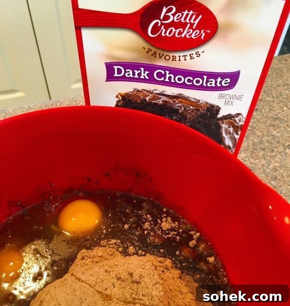 Ultimate Kicked-Up Boxed Brownies Recipe (Fast & Fudgy) 3 Brownie Mix with eggs, water and oil in mixing bowl