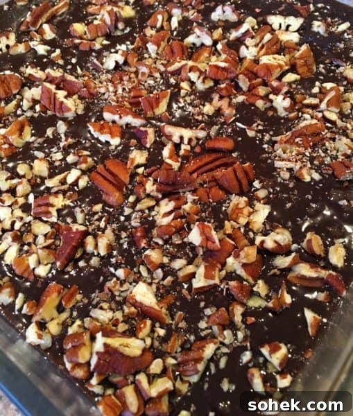 Ultimate Kicked-Up Boxed Brownies Recipe (Fast & Fudgy) 6 Chopped Pecans added to brownie mix in baking dish