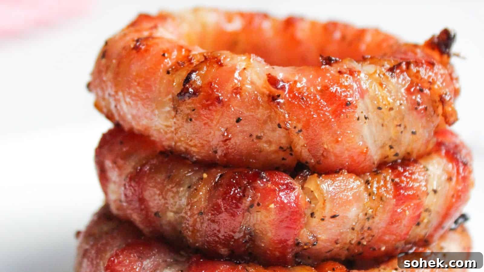 26 Irresistible Air Fryer Game Day Snacks to Serve Guests 11 Stack of bacon wrapped onion rings.