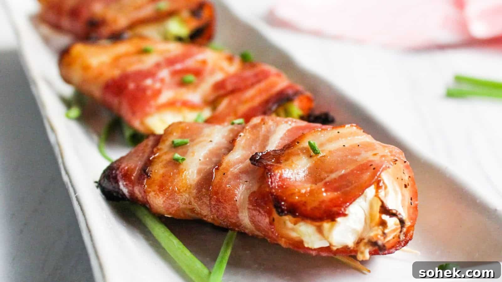 26 Irresistible Air Fryer Game Day Snacks to Serve Guests 12 Bacon wrapped air fryer cabbage on white plate.