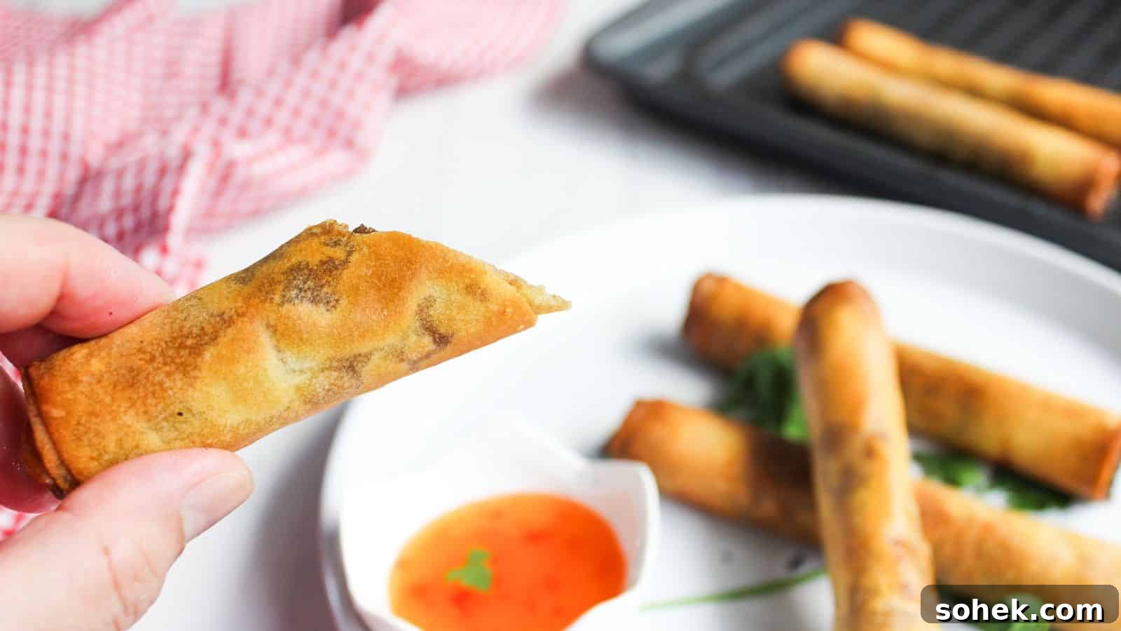 26 Irresistible Air Fryer Game Day Snacks to Serve Guests 21 Filipino spring rolls in a basket with dipping sauce.