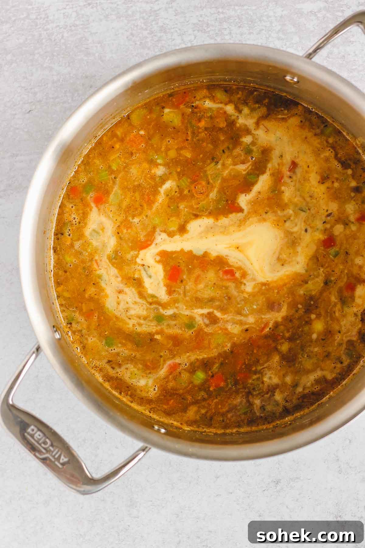 Southwestern Chicken Chili Recipe: Zesty One-Pot Dinner 7 Base of chicken chili in a stainless steel pot with pureed corn being mixed in.