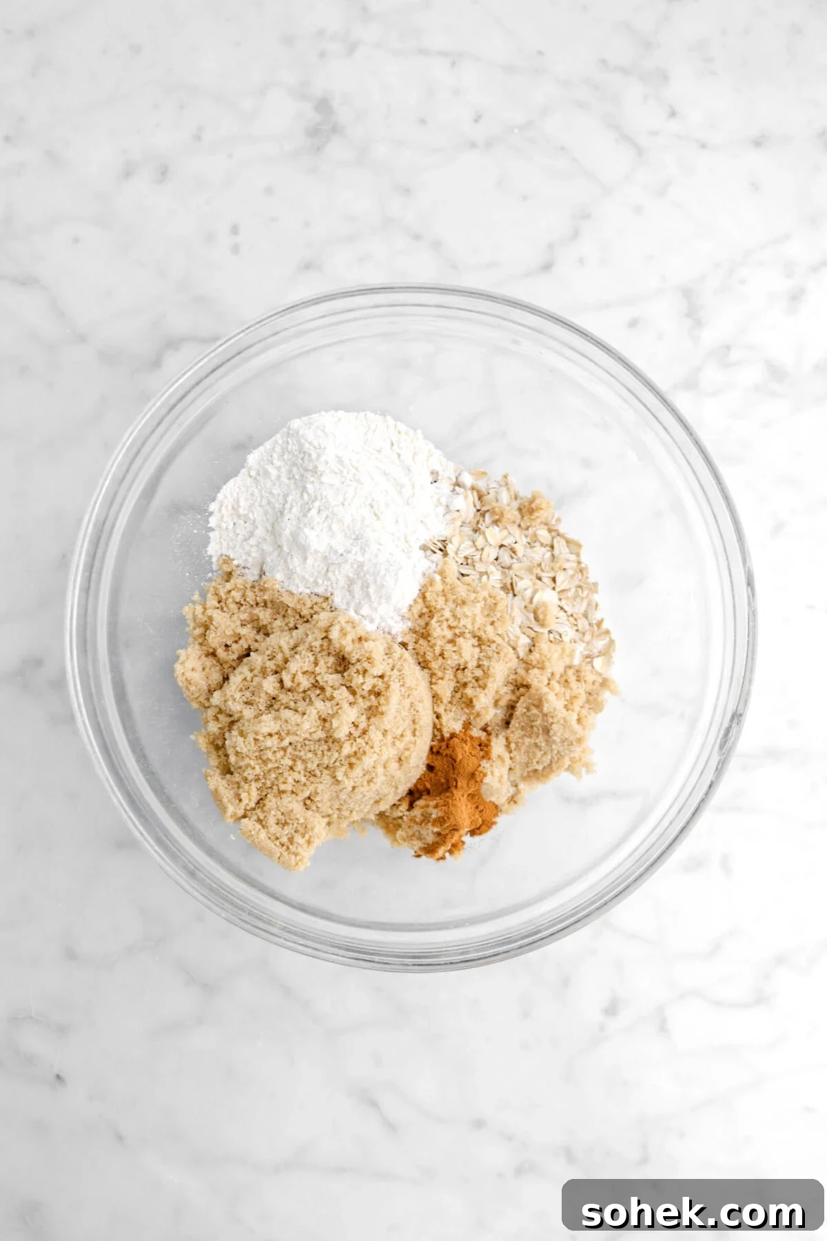 Apple Cranberry Crumble Pie Recipe with Buttery Oat Topping 11 flour, oats, brown sugar, and cinnamon in glass bowl.