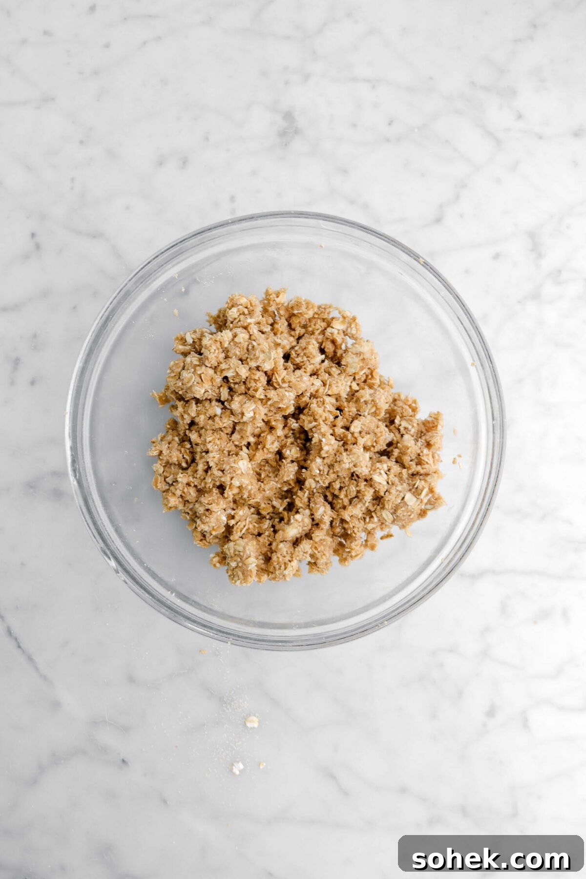 Apple Cranberry Crumble Pie Recipe with Buttery Oat Topping 14 crumble topping in glass bowl.