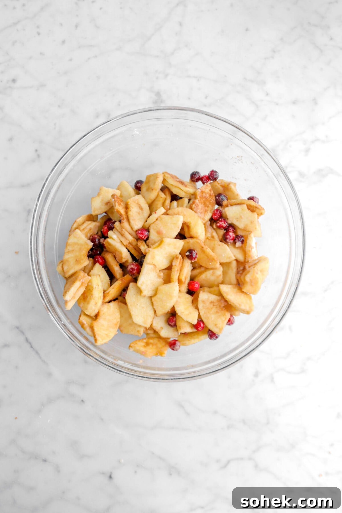 Apple Cranberry Crumble Pie Recipe with Buttery Oat Topping 9 apple cranberry pie filling in glass bowl.
