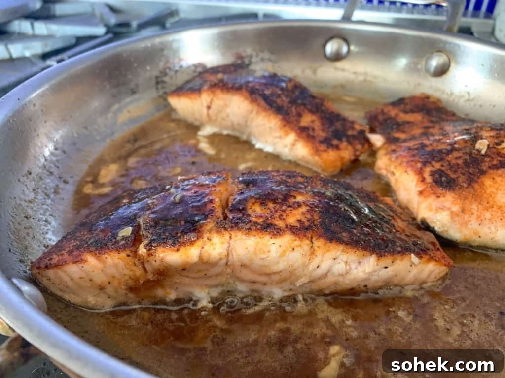 Crispy Salmon Rice Bowl with Fresh Mango Salsa 9 Salmon in butter sauce in a skillet