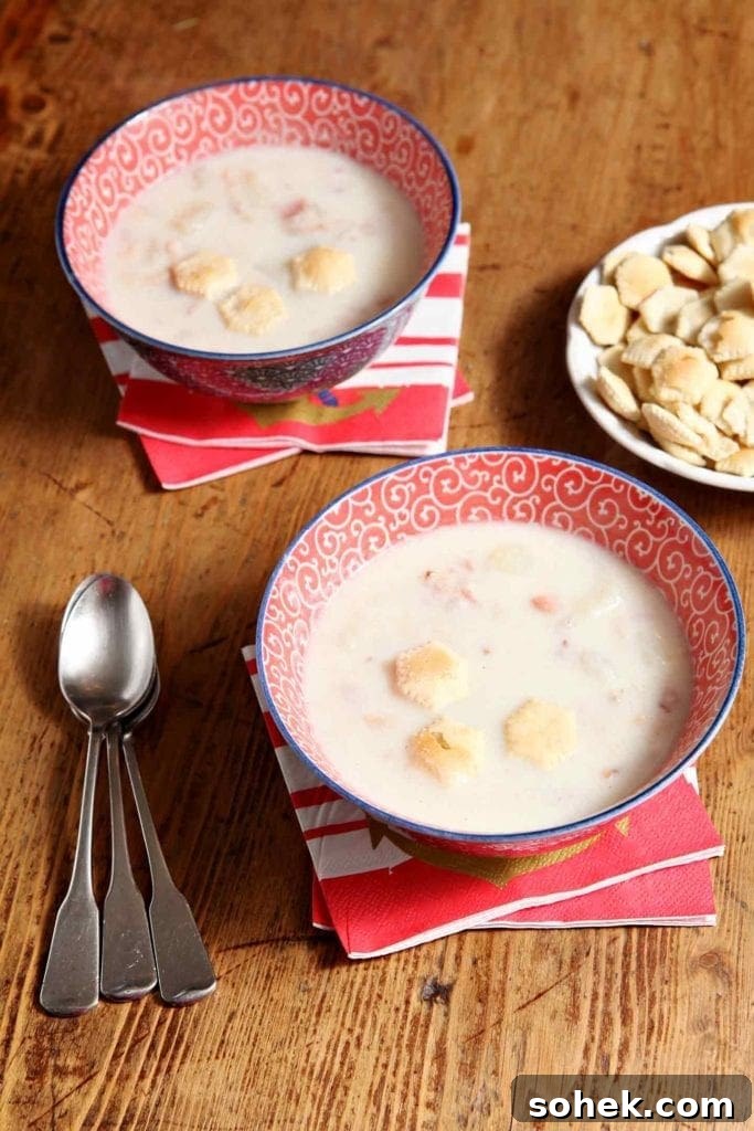 Two bowls of Bob's Bacon Potato Clam Chowder on wood table 