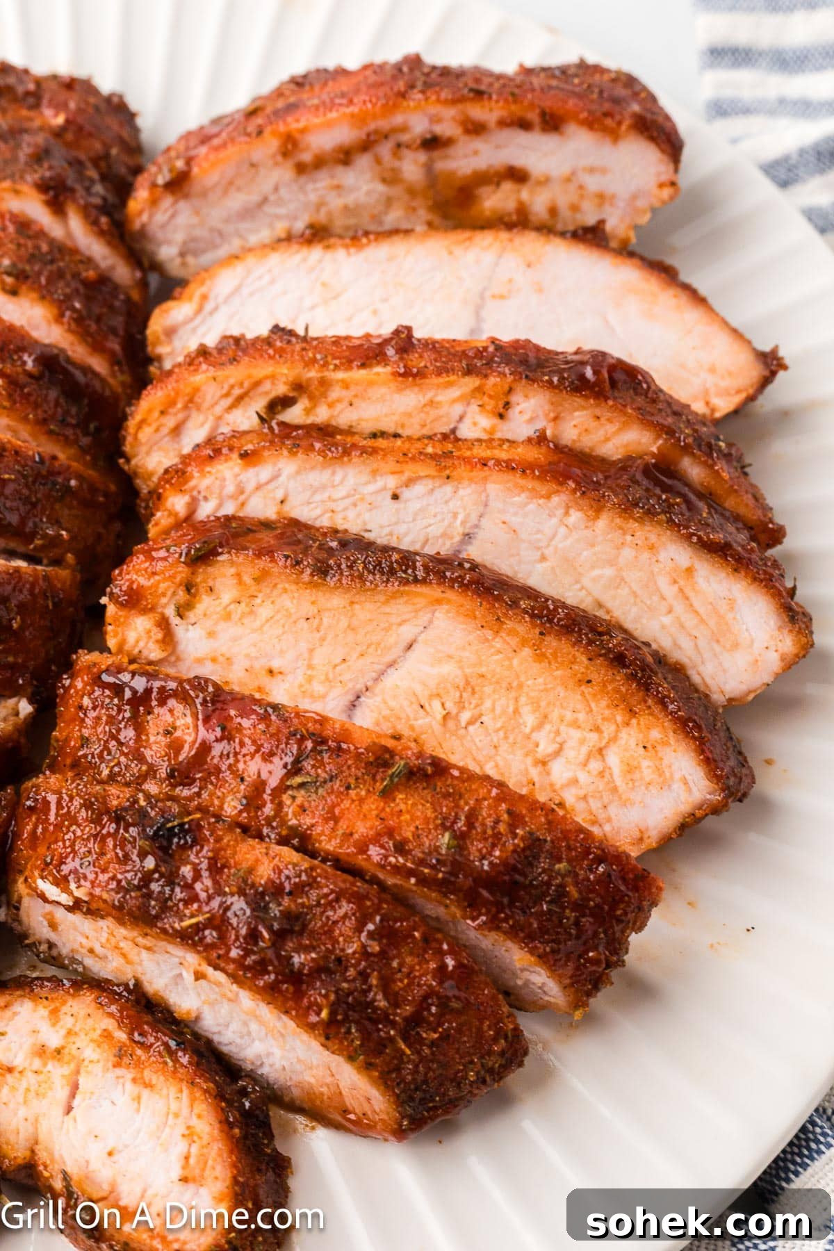 Juicy Grilled Turkey Tenderloin with Garlic Herb Marinade 2 BBQ Turkey Tenderloin sliced on a white platter