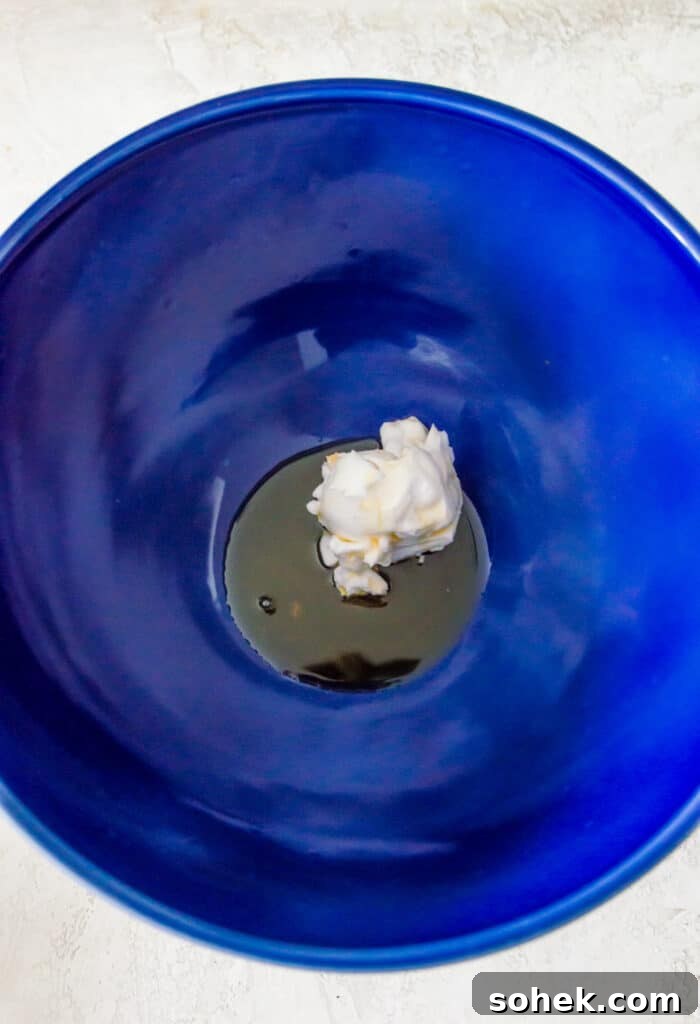 Peanut Butter Mousse with 4 Ingredients — Quick Creamy Dessert 4 A bowl with maple syrup and cream cheese in it.