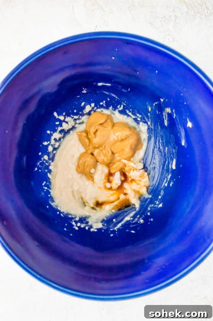 Peanut Butter Mousse with 4 Ingredients — Quick Creamy Dessert 6 A bowl with peanut butter, cream cheese and maple syrup in it.