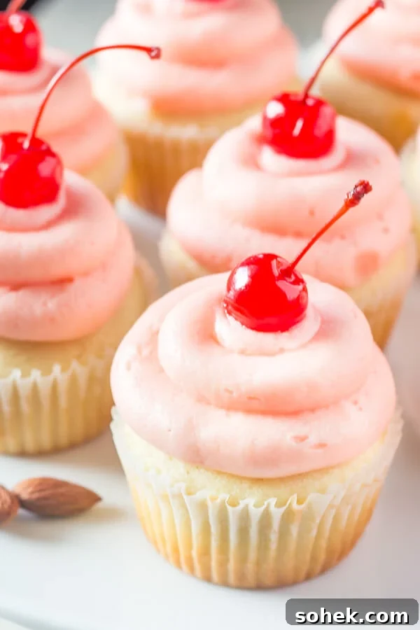 Cherry Almond Cupcakes. Fluffy, moist, super soft almond cupcakes topped with maraschino cherry frosting. www.justsotasty.com