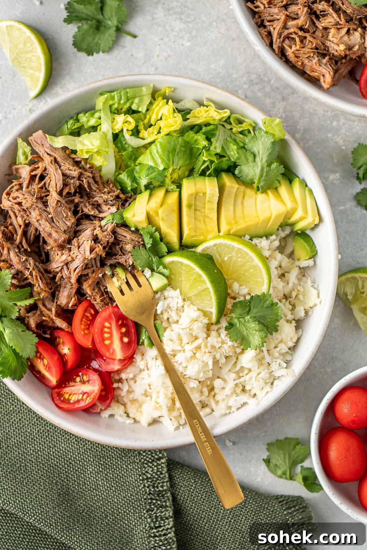 A fork in the shredded beef burrito bowl.