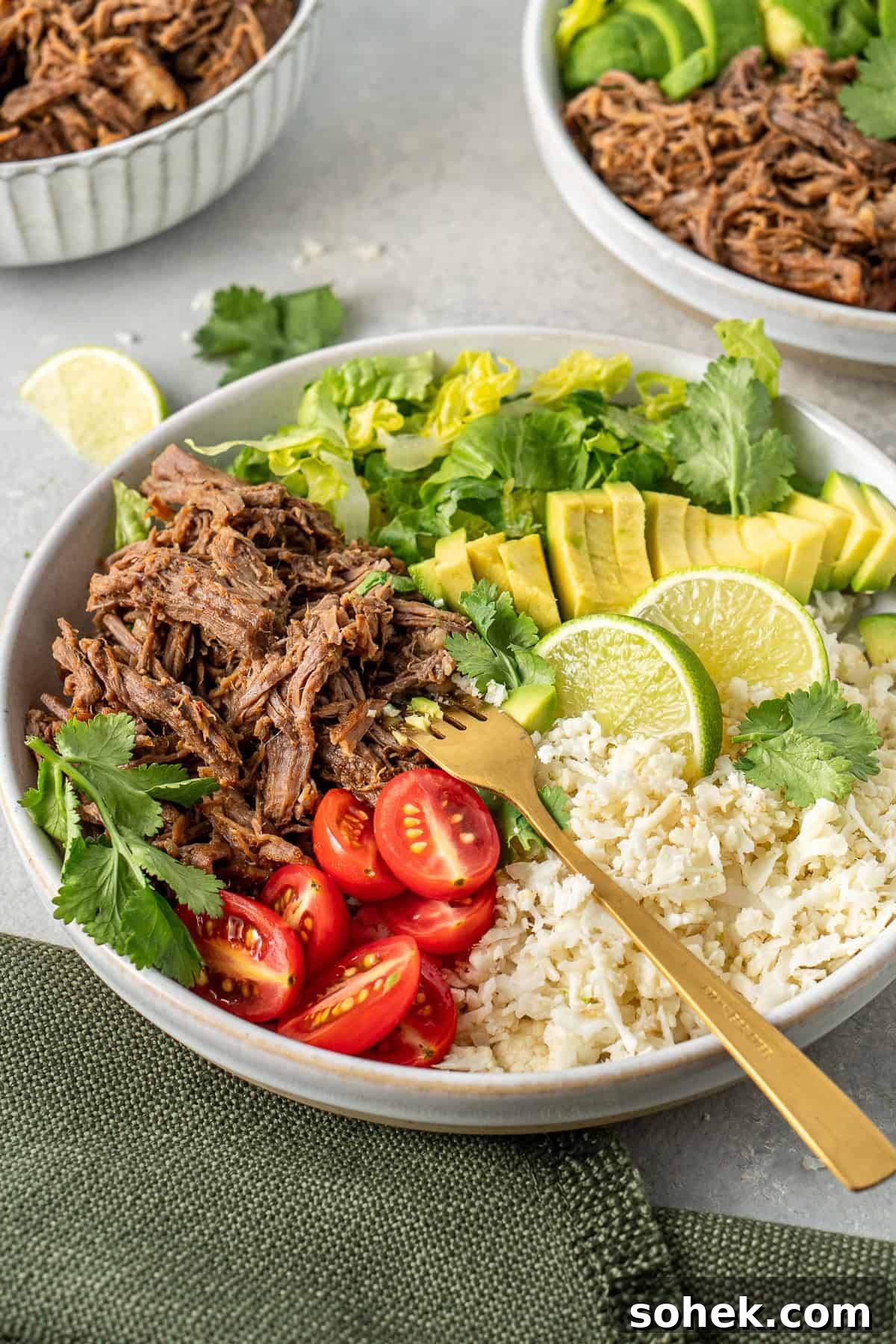Shredded beef bowl with cauliflower rice and salad.