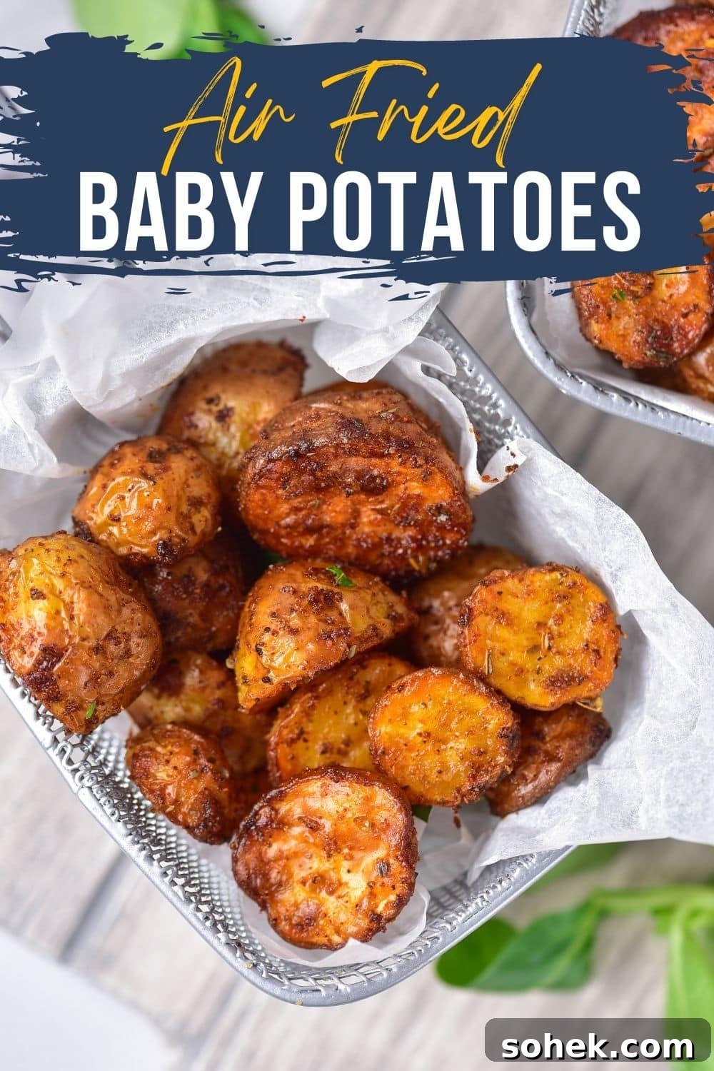 baby potatoes covered in seasoning that have been air fried in an air fryer basket 