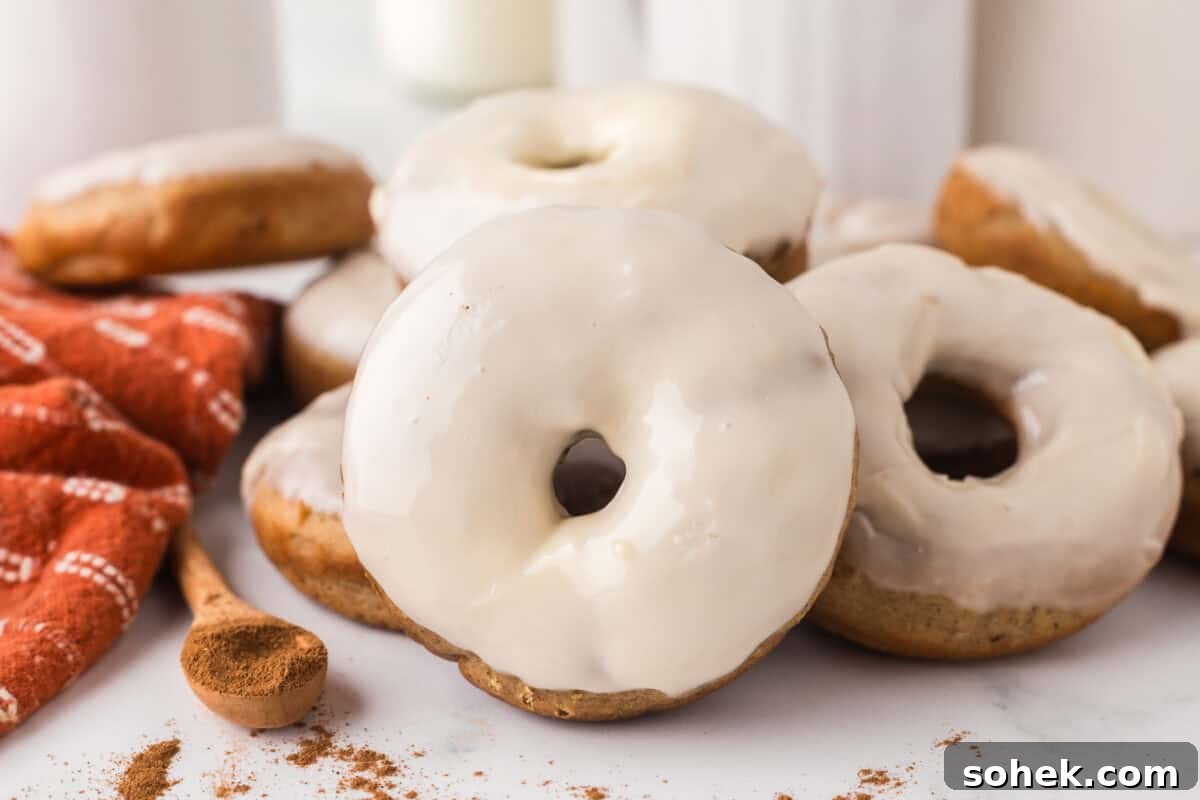Maple-Glazed Donuts: Homemade Recipe and Serving Tips 12 a bunch of Maple Donuts together next to ground cinnamon