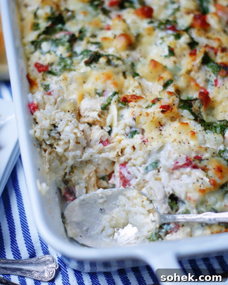 creamy spinach artichoke chicken casserole with rice served with a spoon