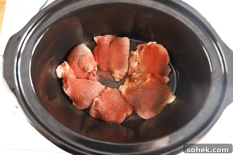 Sticky Slow Cooker BBQ Chicken Thighs Recipe for Tender Meat 4 adding seasoning to the slow cooker