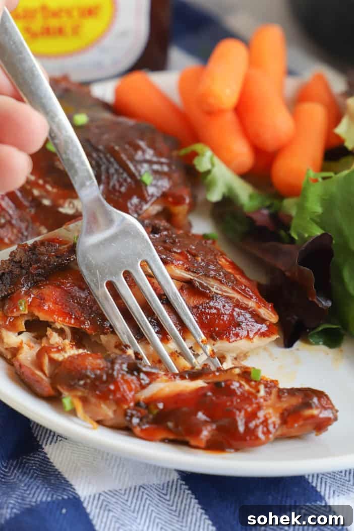 Sticky Slow Cooker BBQ Chicken Thighs Recipe for Tender Meat 6 using a fork to eat Slow Cooker BBQ Chicken Thighs
