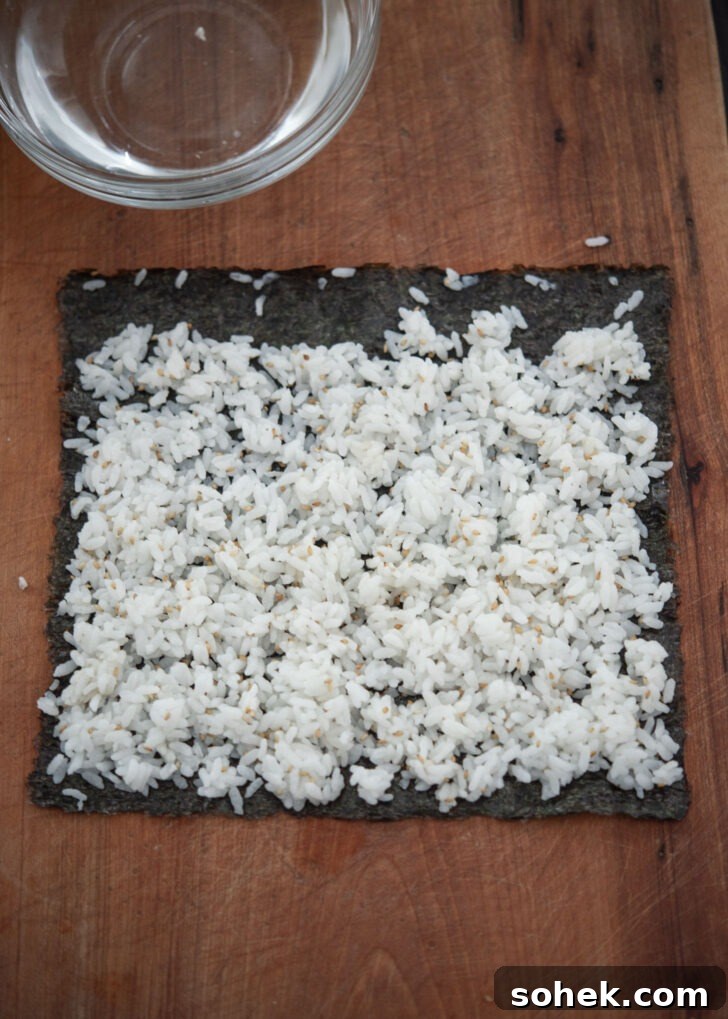 Seasoned rice spread evenly on a sheet of seaweed