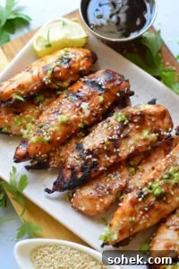 Chicken tenders in teriyaki sauce on a plate.