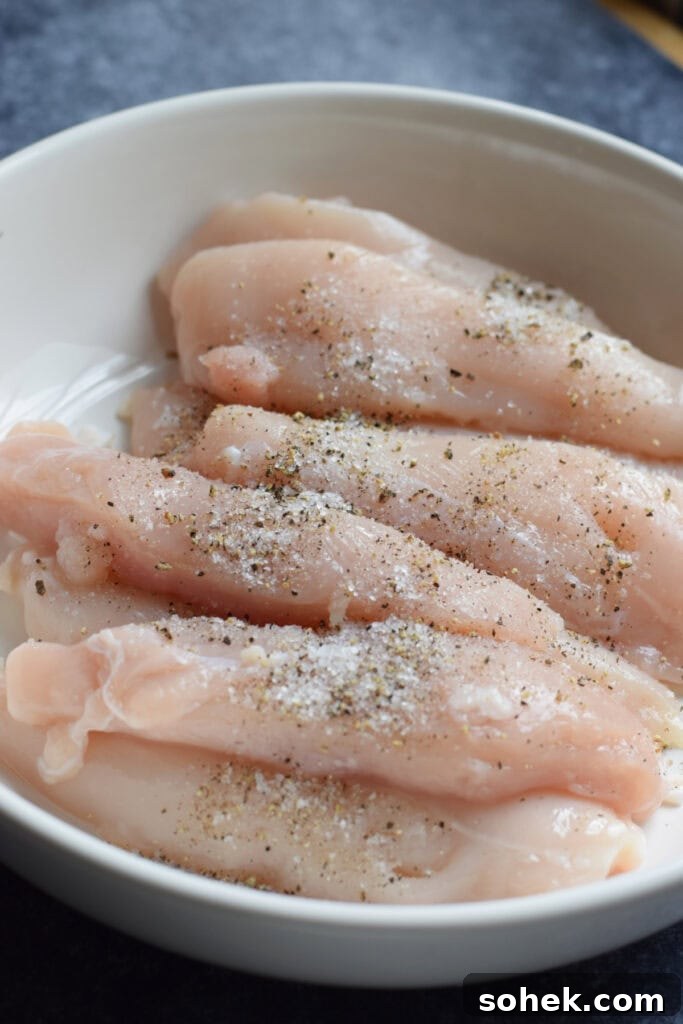 Seasoned chicken tenders in a bowl.