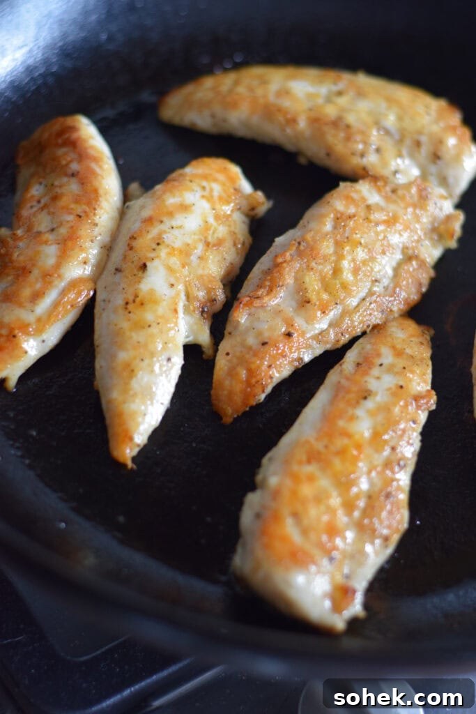 Skillet chicken tenders in a cast iron pan.