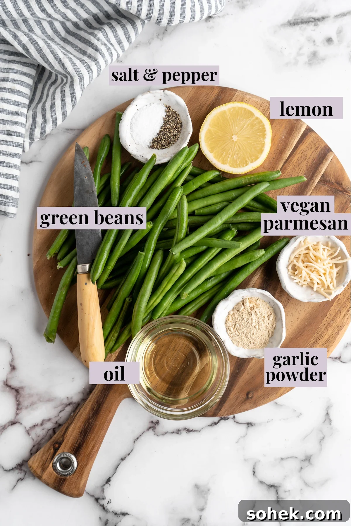 These air fryer green beans are seasoned to perfection and air fried until crispy for an easy side dish that goes with anything! Overhead view of air fryer green bean ingredients with labels.