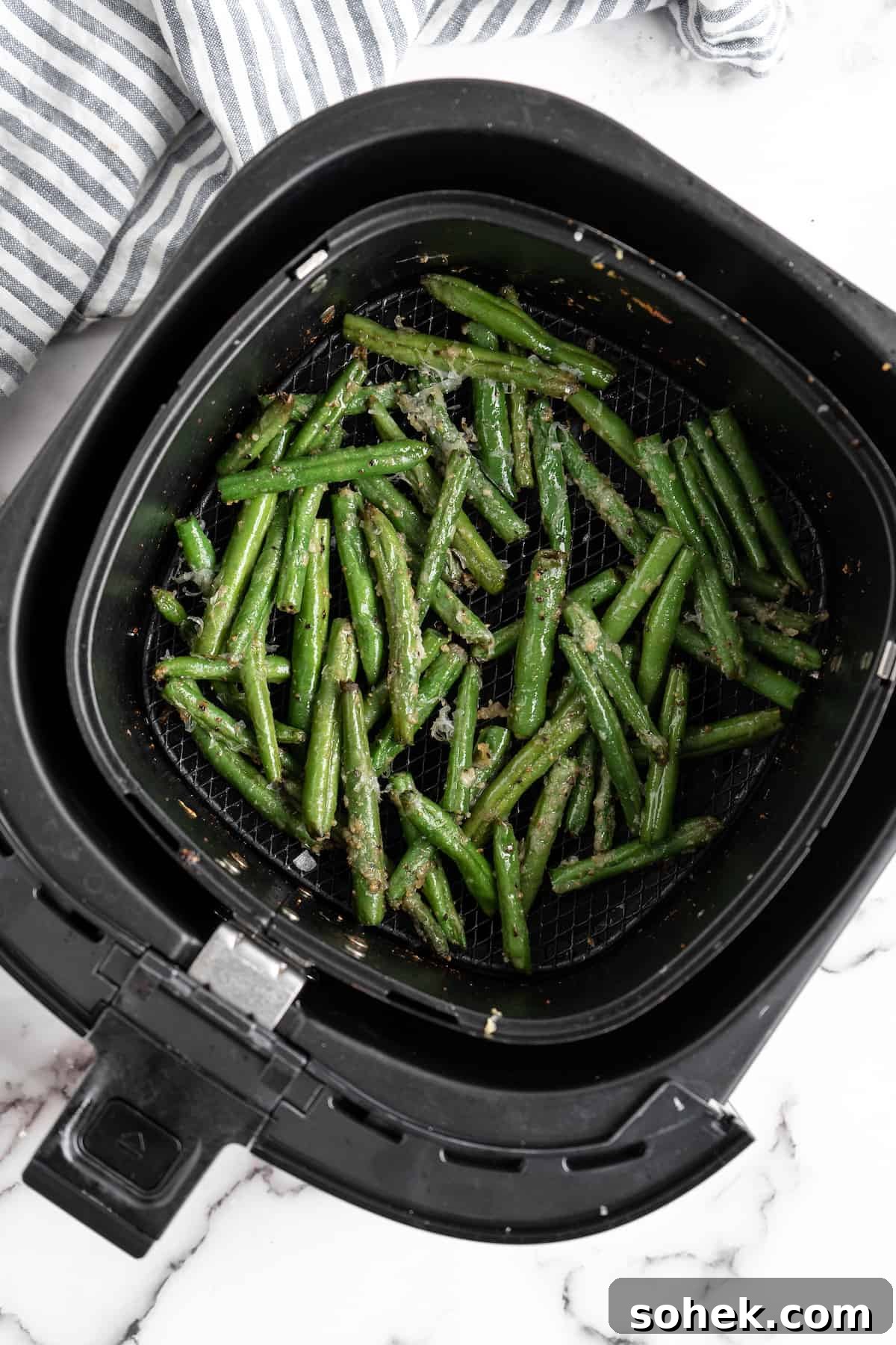 These air fryer green beans are seasoned to perfection and air fried until crispy for an easy side dish that goes with anything! Cooked green beans in air fryer.