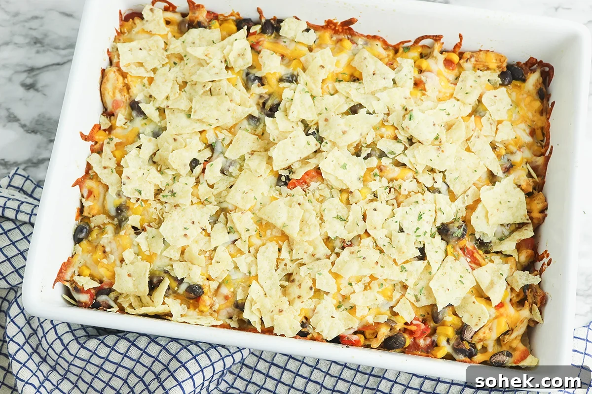 Baked Mexican Chicken Casserole in white baking dish.